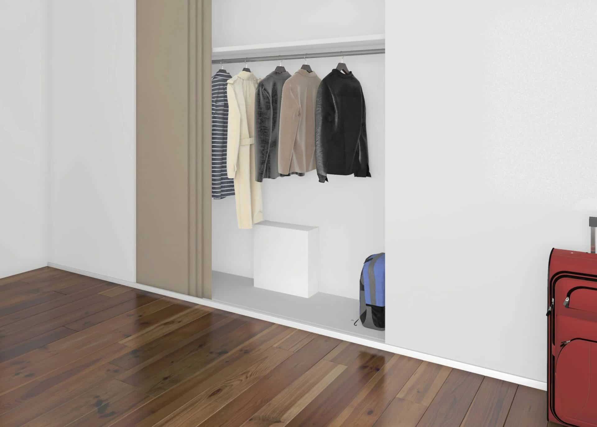 Cache nourrice plomberie blanc intégré dans un placard de chambre avec vêtements suspendus