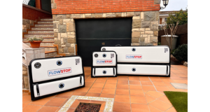 Trois batardeaux gonflables Flowstop de tailles différentes posés sur une terrasse devant la porte de garage d’une maison pour la protection anti inondation